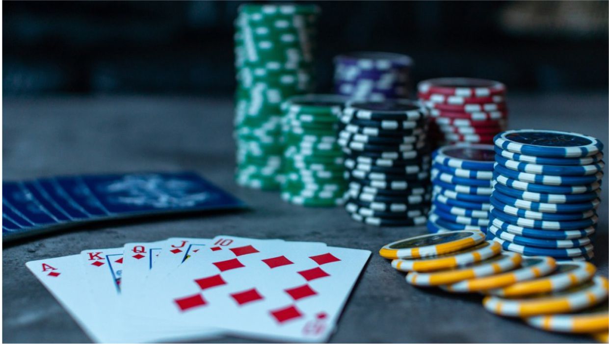 a picture of a man playing cards in a casino